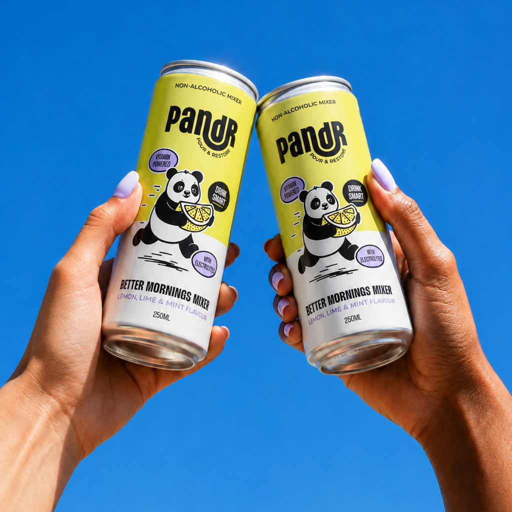 Two hands holding PandR cans against a clear blue sky

